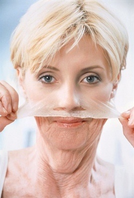 Young-old woman peeling off face
